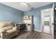 Spacious bedroom features blue walls, hardwood floors, a recliner chair, and a built-in desk at 4214 38Th W St, Bradenton, FL 34205