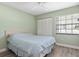 Comfortable bedroom featuring wood floors, a queen bed with a blue comforter, and window with blinds at 4214 38Th W St, Bradenton, FL 34205