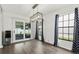 Dining room with wood floors, modern light fixture, sliding glass doors to outdoor patio, and a beverage cooler at 4214 38Th W St, Bradenton, FL 34205