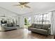Spacious living room with wood floors, neutral-toned sofas, and large windows overlooking the yard at 4214 38Th W St, Bradenton, FL 34205