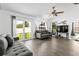 Bright living room featuring wood floors, comfortable seating, and sliding glass doors to the yard at 4214 38Th W St, Bradenton, FL 34205
