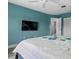 A calming bedroom with blue accents, a ceiling fan, and a door to an ensuite bathroom at 4214 38Th W St, Bradenton, FL 34205
