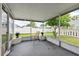 Screened porch with neutral-toned patio chair and serene backyard view at 4214 38Th W St, Bradenton, FL 34205