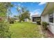 Expansive green backyard with a shed, screened porch, and well-maintained landscaping at 4250 Winfall Ave, North Port, FL 34286