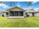 Spacious backyard featuring a screened porch and outdoor dining and entertaining space at 4250 Winfall Ave, North Port, FL 34286