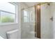 Modern bathroom featuring a glass shower with gold trim and marble tile at 4250 Winfall Ave, North Port, FL 34286