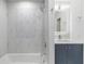 Bright bathroom featuring sleek shower, modern vanity, and marbled tiling at 4250 Winfall Ave, North Port, FL 34286