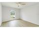 This bedroom offers wood-look flooring, a modern ceiling fan, and a bright window at 4250 Winfall Ave, North Port, FL 34286