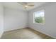 This bedroom offers wood-look floors, a modern ceiling fan, and a bright window at 4250 Winfall Ave, North Port, FL 34286