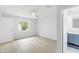 Bright bedroom featuring light wood floors, a ceiling fan, and an ensuite bathroom at 4250 Winfall Ave, North Port, FL 34286