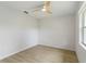 This bedroom offers wood-look floors, a modern ceiling fan, and a bright window at 4250 Winfall Ave, North Port, FL 34286