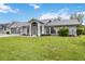 Charming single-story home featuring arched windows and a well-manicured front lawn at 4250 Winfall Ave, North Port, FL 34286