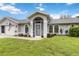 Beautiful single-story home featuring arched windows, a screened entry, and landscaped yard at 4250 Winfall Ave, North Port, FL 34286