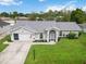 Inviting single-story home with a screened entry, arched windows, and beautiful landscaping at 4250 Winfall Ave, North Port, FL 34286