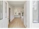Bright and airy foyer featuring stylish light-colored floors that flow into the kitchen and main living areas at 4250 Winfall Ave, North Port, FL 34286
