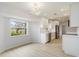 Modern kitchen featuring stainless steel appliances, white cabinets, and a large window overlooking the yard at 4250 Winfall Ave, North Port, FL 34286
