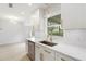 Bright kitchen featuring white cabinets, gold hardware, stainless steel appliances, and a large window at 4250 Winfall Ave, North Port, FL 34286