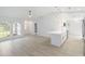 Open-concept living space featuring a modern kitchen with quartz countertops and a peninsula with seating at 4250 Winfall Ave, North Port, FL 34286