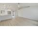 Open-concept living area with light-colored flooring, a modern kitchen, and access to an outdoor patio area at 4250 Winfall Ave, North Port, FL 34286