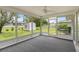 Enclosed screen porch with outdoor views of the yard and shed with carpet flooring and ceiling fan at 4250 Winfall Ave, North Port, FL 34286