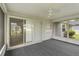 Relaxing screened porch with fan, carpet, and access to outdoor green space at 4250 Winfall Ave, North Port, FL 34286