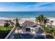 Aerial view showcasing a beachfront community building and ocean access at 4420 Exeter Dr # 303, Longboat Key, FL 34228