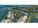 Aerial view of condo complex with waterfront access, boat slips, parking, and lush landscaping at 4420 Exeter Dr # 303, Longboat Key, FL 34228