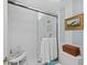Bathroom with glass-enclosed shower, white tile, and classic fixtures at 4420 Exeter Dr # 303, Longboat Key, FL 34228