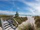 Beach access featuring stairs through dunes leading to the sandy shoreline at 4420 Exeter Dr # 303, Longboat Key, FL 34228