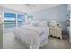 Serene bedroom with water view featuring crisp white bedding and shuttered windows at 4420 Exeter Dr # 303, Longboat Key, FL 34228