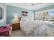 Comfortable bedroom featuring a floral comforter, ceiling fan, and window shutters at 4420 Exeter Dr # 303, Longboat Key, FL 34228