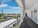 Exterior walkway with palm trees, leading to condo units with covered parking view at 4420 Exeter Dr # 303, Longboat Key, FL 34228