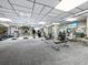 Bright gym with treadmills, elliptical machines, weights, and a flat screen TV at 4420 Exeter Dr # 303, Longboat Key, FL 34228