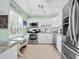 Cozy kitchen with white cabinets, stainless steel appliances, and a 'Beach House' sign at 4420 Exeter Dr # 303, Longboat Key, FL 34228
