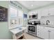 Bright kitchen with stainless steel appliances and a charming window view at 4420 Exeter Dr # 303, Longboat Key, FL 34228