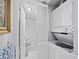 Functional laundry area with stacked washer and dryer near a bathroom at 4420 Exeter Dr # 303, Longboat Key, FL 34228