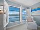 Sitting area with water views, shuttered windows, and a cozy patterned armchair at 4420 Exeter Dr # 303, Longboat Key, FL 34228