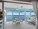 Bright sunroom with tile floors, modern furnishings and panoramic views of the water at 4420 Exeter Dr # 303, Longboat Key, FL 34228