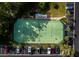 Aerial shot of community tennis courts with players in action, surrounded by lush landscaping and parking at 4420 Exeter Dr # 303, Longboat Key, FL 34228