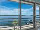 Beautiful waterfront vista with a palm tree and private boat dock at 4420 Exeter Dr # 303, Longboat Key, FL 34228
