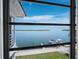 Breathtaking water view through a window overlooking a boat dock at 4420 Exeter Dr # 303, Longboat Key, FL 34228
