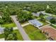 Charming home features a metal roof, spacious yard, and is surrounded by lush greenery at 4855 Dragon St, North Port, FL 34288