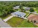 Beautiful home with metal roof and fenced yard, surrounded by mature trees and landscaping at 4855 Dragon St, North Port, FL 34288