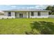 View of the backyard, the rear of the house, and a vibrant green lawn at 4855 Dragon St, North Port, FL 34288