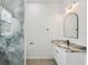 The bathroom has a marble-style shower and granite vanity with black hardware at 4855 Dragon St, North Port, FL 34288