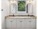 Elegant bathroom featuring double vanities, modern fixtures, and arched mirrors at 4855 Dragon St, North Port, FL 34288