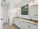 Elegant bathroom featuring double vanities, modern fixtures, and arched mirrors at 4855 Dragon St, North Port, FL 34288