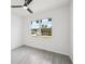 A bedroom featuring wood-look tile flooring and a window showing the neighborhood outside at 4855 Dragon St, North Port, FL 34288
