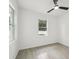 Comfortable bedroom with ceiling fan, tile floors, and lots of natural light at 4855 Dragon St, North Port, FL 34288