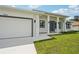 A close-up of a modern home with a two-car garage, walkway, and freshly landscaped yard at 4855 Dragon St, North Port, FL 34288